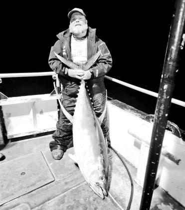 Jason Barber with the 110-pound yellowfin tuna he caught on a topwater plug around Hoover Diana platform, roughly 130 miles offshore from Port Aransas. COURTESY PHOTO / JASON BARBER