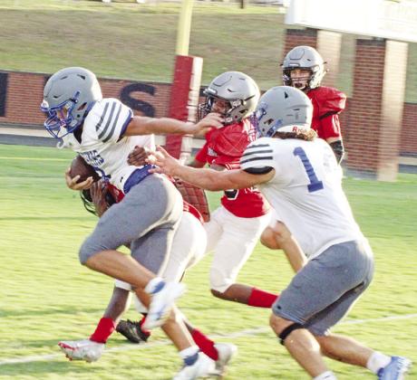 Pewitt’s Champ Bailey breaks away from the Hughes Springs defense during their scrimmage Thursday. The Brahmas open their season Friday at Winnsboro.