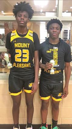Freshman guard Reggie Webster (L) and junior guard Kelcey Morris (R) pose with their all-tournament trophies. COURTESY PHOTO / DREW BARKLEY