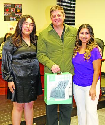 Dr. Kenny Thompson accepts a gift from Marcela Mata and Madeline Plascencia from Mount Pleasant High School COURTESY PHOTOS