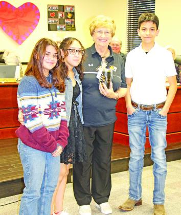 Mount Pleasant Junior High students Sabrina Otero-Svirska, Allison Mendoza, and Isaac Hernandez honor Yvonne Hampton