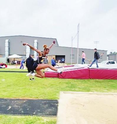 Ladi Guereca flies into the pit during long jump.