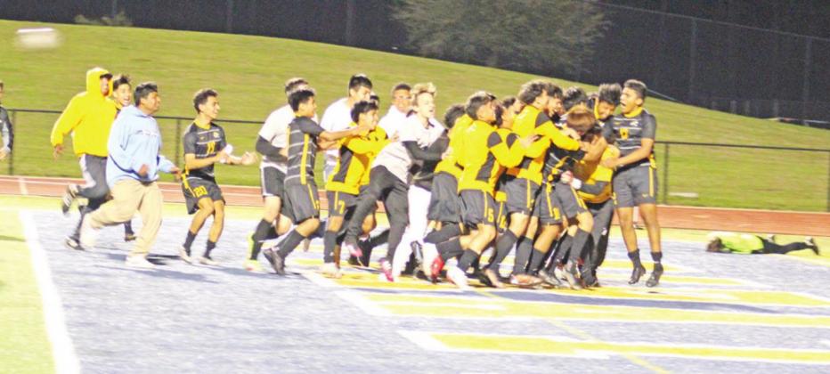 The Mount Pleasant soccer team mobs goalie Bobby Gandara after his save in penalty kicks that clinched the win for the Tigers. TRIBUNE PHOTOS / QUINTEN BOYD