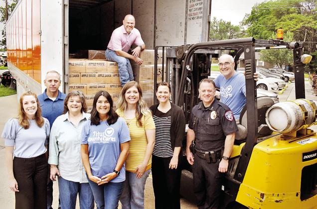 On hand to assist in the truck’s delivery on May 10 were from left to right: From left: Mount Pleasant City and The Church of Jesus Christ Latter-day Saints leaders Diana Bonney, Jack Jones, Sherri Spruill, Kim Hedges, Melissa Moulton, Kellie Richins, Mark Buhman, and Rob Holliday. Brandon Dodd is in the truck. Not pictured: Mount Pleasant City Manager Ed Thatcher and Mount Pleasant LDS member Joanne Christian. COURTESY PHOTO