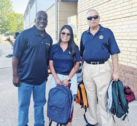 Rotarians volunteered to hand out backpacks during the drive-through event.