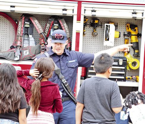 A local Firefighter explains the equipment carried on a firetruck