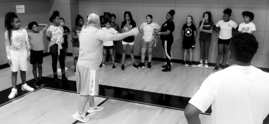 Coach Marshall and Coach Farrier instruct the girls. PHOTO BY CRYSTAL JACKSON