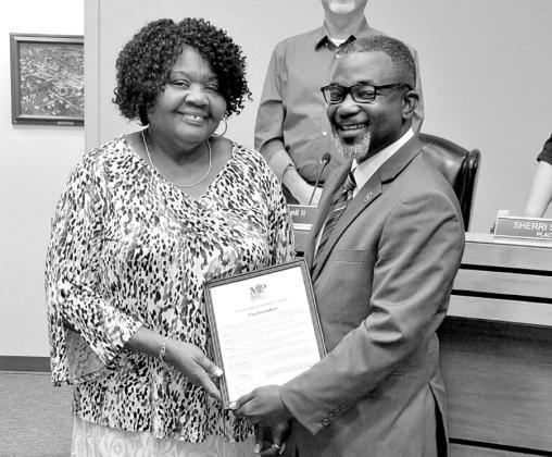 Mrs. Mae Lois Tudman White with City of Mount Pleasant Mayor Tracy Craig, Sr., as the City Council including Councilmember Henry Chappell, II, in the background honored the long-time citizen during the September 6 City Council meeting. COURTESY PHOTO