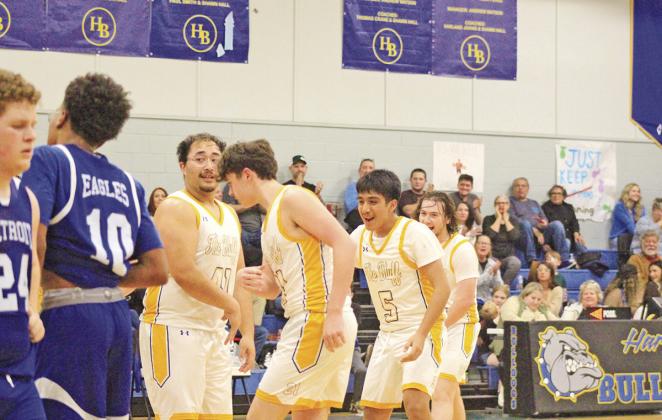 From left, Harts Bluff’s Landon Wisinger celebrates with teammates Brady Cook, Yonathan Bocanegra and Hunter Green after a layup by Wisinger during Friday’s Homecoming game against Detroit. The Bulldogs won, 73-17.