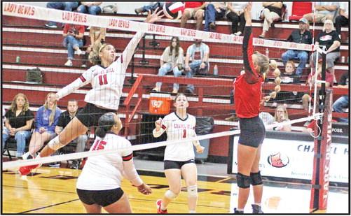 Chapel Hill’s Cailyn Johnson tips a ball over the net while teammates Soraya Solis (left) and Kaylee Tompkins (right) look on. The Lady Devil volleyball team kicked off district play Friday at home against Quitman on the strength of a four-match win streak. Chapel Hill swept Liberty-Eylau and James Bowie, 3-0, won at Pittsburg, 3-1 and picked up a 3-1 win over CHESS Tuesday. The Lady Devils are 13-13 on the season. TRIBUNE PHOTO / QUINTEN BOYD