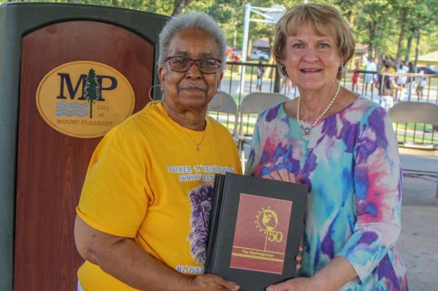 Above from left, Betty Roberson, President of Booker T. Washington High School Alumni Association Council, presented a set of the five recovered and re-published Booker T. Washington High School yearbooks to Helen Thompson, Director of the Mount Pleasant Library. COURTESY PHOTO
