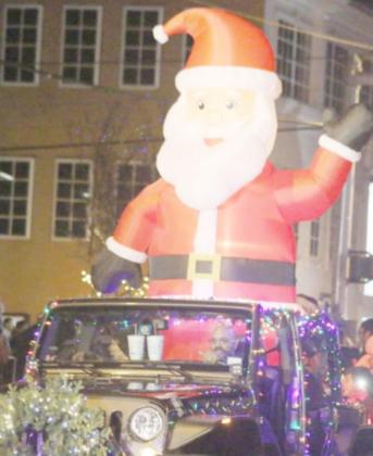 An inflatable Santa sits atop a decorated vehicle at the 2019 Christmas parade. FILE PHOTO