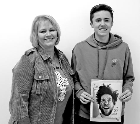 BIM I instructor Jackie Scoggins with Lee Davis holding the autographed photo from L.A. Beast. COURTESY PHOTO
