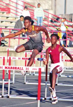 Isaiah Hunter competes in the hurdles.