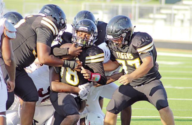 With help from his offensive line, Mount Pleasant’s Omari Peters powers through the Liberty-Eylau defense during Thursday’s game. The freshmen Tigers defeated the Leopards, 26-0. TRIBUNE PHOTO / QUINTEN BOYD