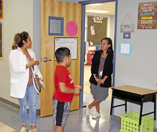 Fowler teacher, Evelyn Gallardo, visits with a student and parent