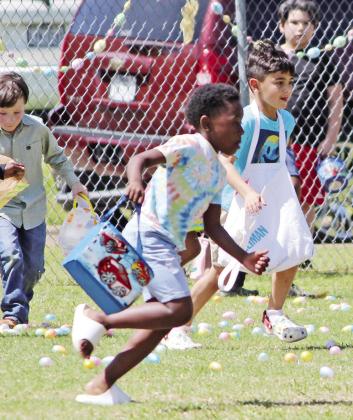 This eager little boy immediately sprinted off to collect the Easter eggs. TRIBUNE PHOTOS / RYLEIGH STEGALL