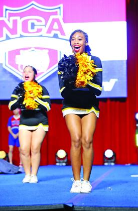 Shannon Hines (front) and Ana’liece Guerrero cheer for the Tigers