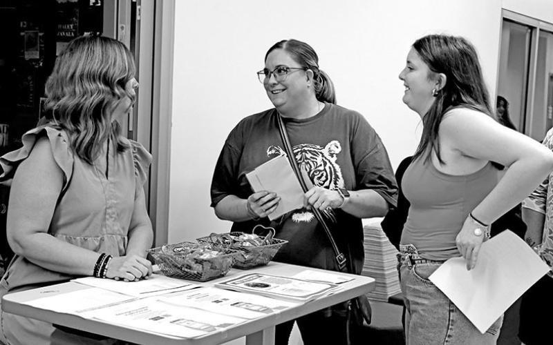 Sarah Carrell speaks to a high school student about health science.