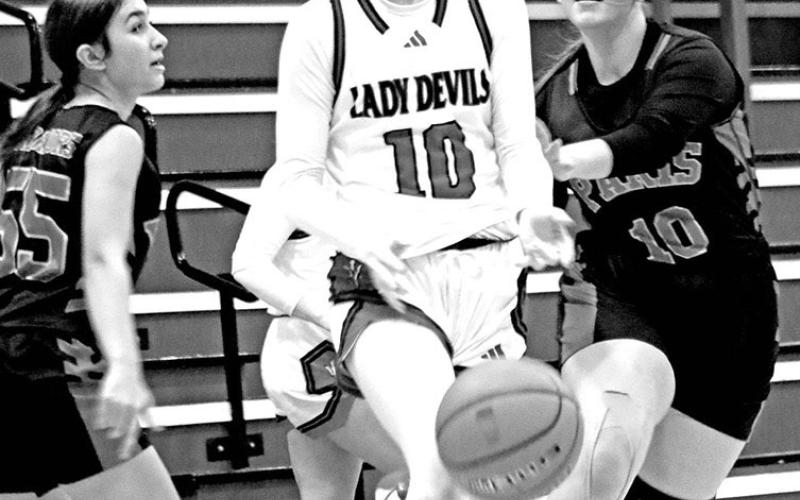 Chapel Hill’s Keira Hawkins (10) splits two defenders on her way to the basket during a recent home game. TRIBUNE PHOTOS / MICHAEL S. MCCRACKEN