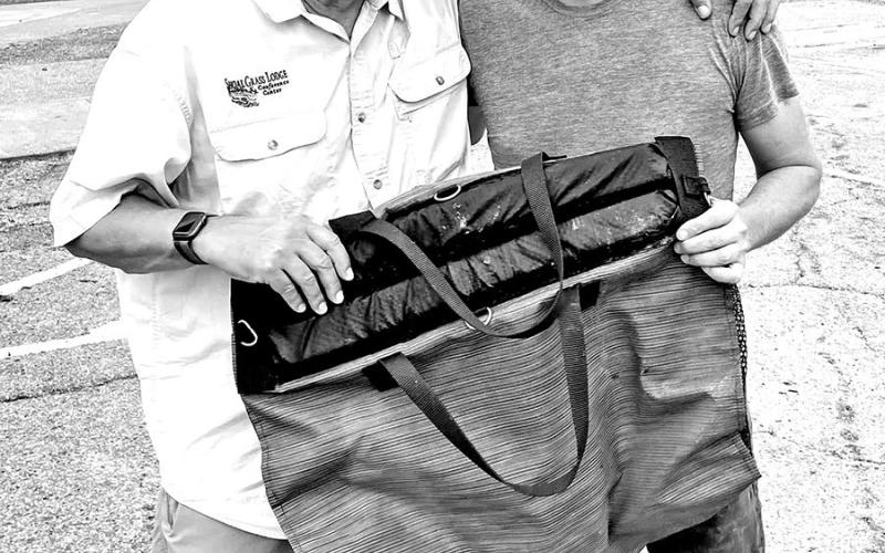 Pipkin managed to keep the fish in good shape until TPWD arrived by keeping it in a breathable mesh bag provided by his good friend, Tim Fading (left) of Austin.