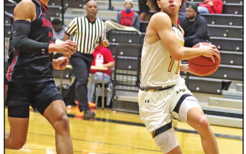Payton Chism drives to the basket against Marshall. PHOTO BY JOHN WHITTEN