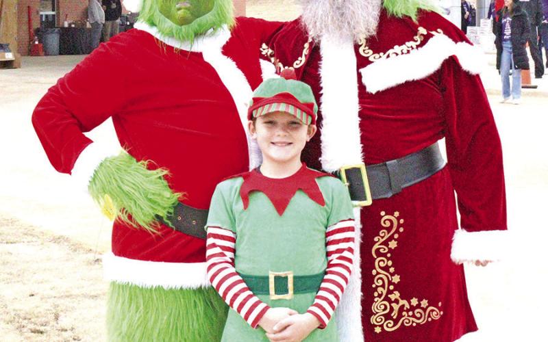The Grinch, Santa Claus, and elf spread joy