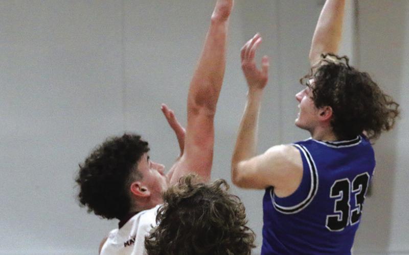 Rivercrest’s Noah Altal puts up a shot over Maud’s Lane Sultz during Tuesday’s game. The Rebels fell against the Cardinals, 59-48. Rivercrest opens the playoffs at 6 p.m. Tuesday against North Hopkins at Mount Vernon High School. PHOTO BY QUINTEN BOYD