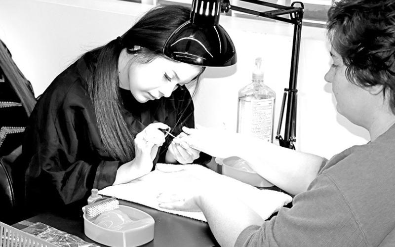 A customer gets a manicure from junior, Jazelyn Zaldivar