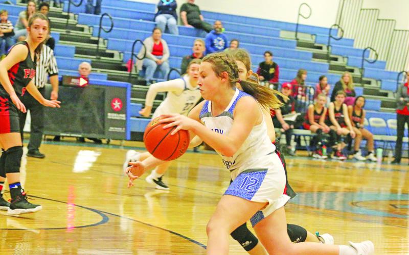 Alexis Case drives toward the basket for the Rivercrest Lady Rebels last Thursday. The Lady Rebels fell in their final two games of 2022 against Paris Warriors and Bloomburg.