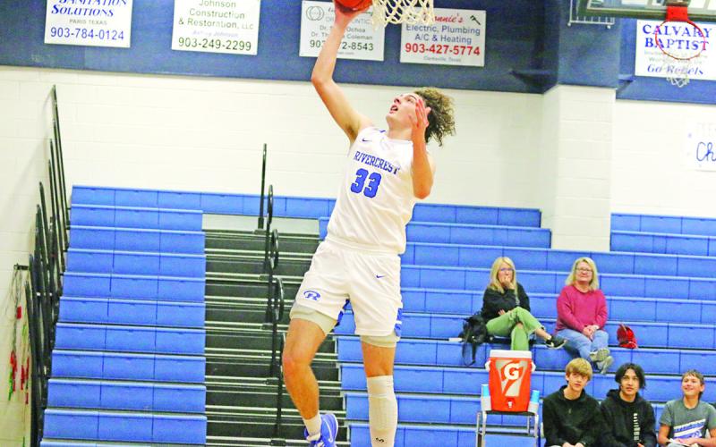 Rivercrest’s Noah Altal soars for a layup during Friday’s game. The Rebels rolled to an 80-20 win over Bloomburg in their 2022 finale. TRIBUNE PHOTO / QUINTEN BOYD
