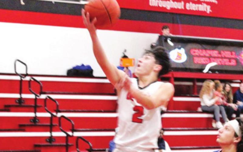 Adrian Ramirez puts up a shot during Tuesday’s game. Ramirez scored six in the Red Devils’ win over Quitman. TRIBUNE PHOTO / QUINTEN BOYD