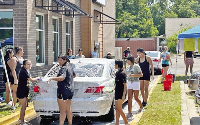 On July 29, Mount Pleasant High School color guard organized a carwash with the goal of raising funds for their dues and other fees. A total of 52 students worked in different shifts and the event was a busy one, running from 10 a.m. to 3 p.m. TRIBUNE PHOTO / CHRISTIE BURNETT