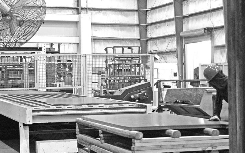 The large automated crane tasked with sorting, stacking, and removing heavy sheets of metal for processing. Plans are moving forward for a second crane to be installed in the open space in the foreground. TRIBUNE PHOTOS / ELIZABETH LANNING