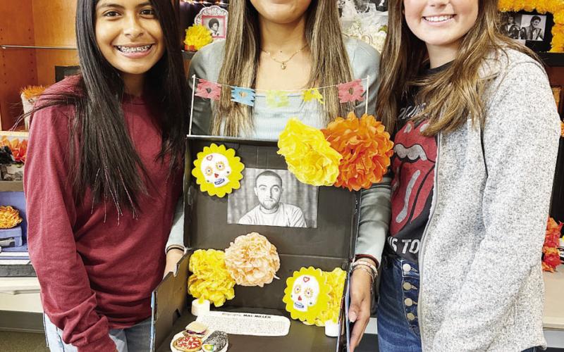 COURTESY PHOTOS (Above) Lef to right: Mishelle Ysasi, Morgan Zepeda, and Haley Garcia with their ofrenda to Michael Jackson; (Right) Eilene Martinez, Jannely Aguilar, and Kenlee Jaggers display their ofrenda to Mac Miller. (Below) Logan Curley presents her ofrenda to King Von.