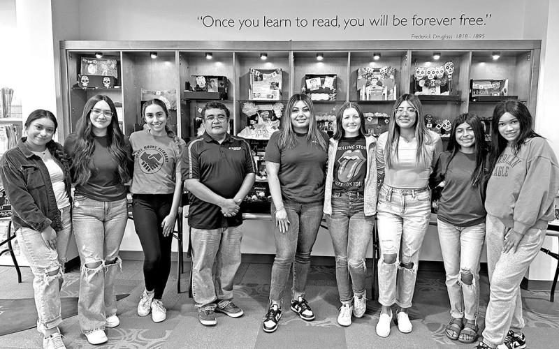 MPHS Spanish II students and teachers with their display of ofrendas at the Mount Pleasant Public Library. COURTESY PHOTO