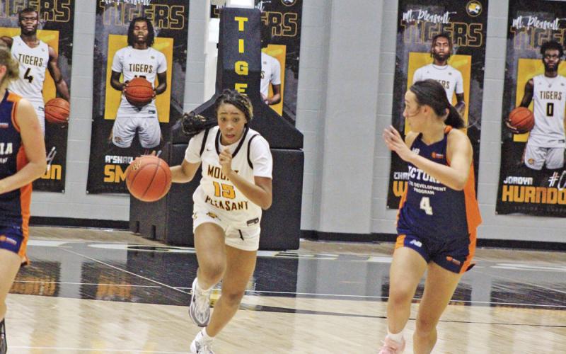Mount Pleasant’s Shannon Hines dribbles past Basketball Victoria’s Indiana de Dios during Tuesday’s game. Basketball Victoria picked up the win in the girls’ matchup. TRIBUNE PHOTO / QUINTEN BOYD