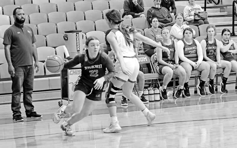 Rivercrest’s Anna Duvall drives toward the basket as Head Coach Joshua Medlock looks on during Tuesday’s game at Chisum. TRIBUNE PHOTO / QUINTEN BOYD