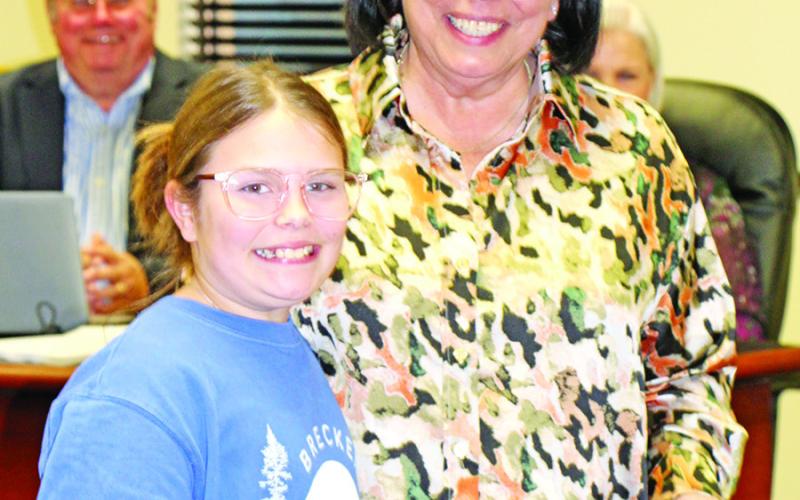Annie Crabb presents Kim Crabb a gift from Sims Elementary