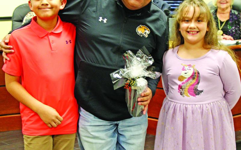 Juan Duenez receives a gift from Cristian DeLaHoya and Isabel Klump from Fowler Elementary