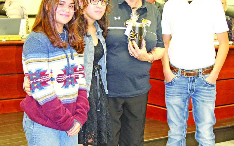 Mount Pleasant Junior High students Sabrina Otero-Svirska, Allison Mendoza, and Isaac Hernandez honor Yvonne Hampton