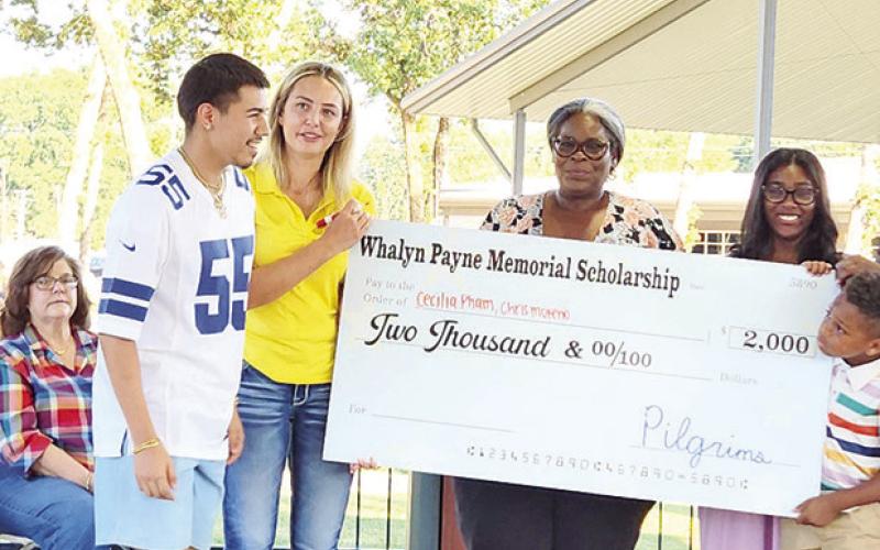 Christopher Moreno grins as he gets on stage to receive his scholarship