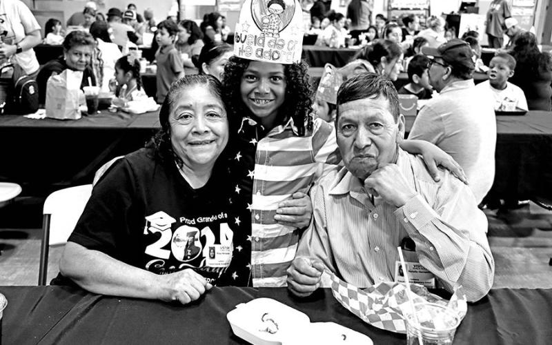 Lucas Cheatham (center) enjoys lunch with his grandparents Blasa and Natalio Hernandez at Frances Corprew Elementary.