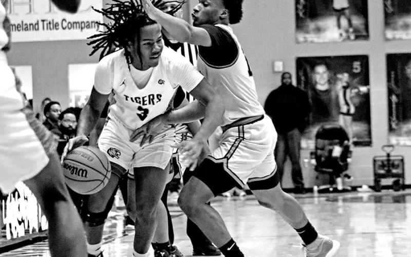 Getting Past The Defense Tiger guard A’Shad Smith (3) gets past a Texas High defender during a recent home game. Coach Joey Chism’s Tigers headed into this week all alone in second place at 10-1 in District 10-5A, just one game behind league-unbeaten Lufkin. Mount Pleasant will travel to Lufkin this Friday night.