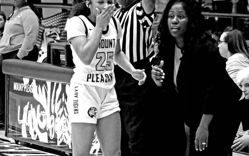 Going Over Strategy Lady Tiger varsity head coach Crystal Jackson-James listens to Kaylin Brannon (25) during a stoppage of play during a recent home game. Heading into this week, the Lady Tigers were sitting in third place in District 10-5A at 9-4 with an overall record of 15-9.