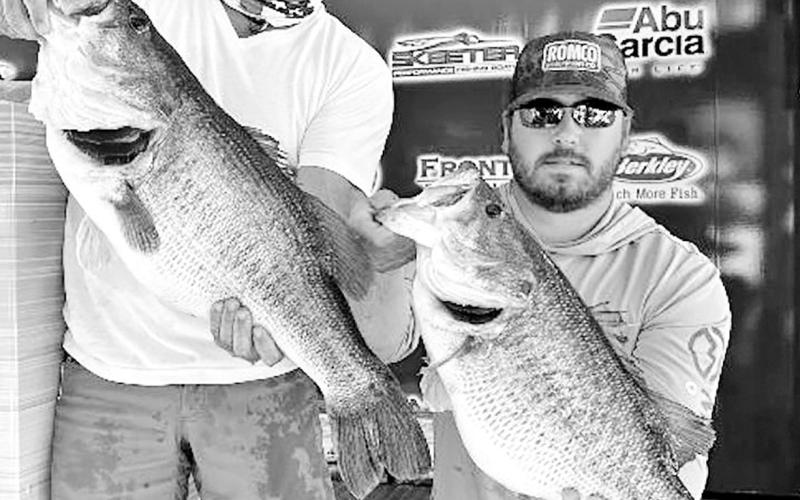 Lee Beuershausen of Marble Falls (left) and Carson Bowen of Burnet were on some big ones during the Bass Champs team event held at Lake O.H. Ivie. The two anglers weighed in a hefty 36.59-pound sack that was anchored by these two giants, a 13.54 pound Legacy Lunker and a 11.5 pounder. BASS CHAMPS PHOTO