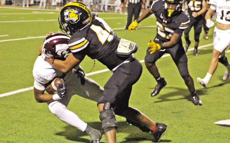 Mount Pleasant’s Jacori Turner brings down Whitehouse’s Jayron Williams as teammate Zy Woodard backs up the play. The Tigers travel to Longview to take on Pine Tree Friday at 7:30 p.m. TRIBUNE PHOTO / QUINTEN BOYD