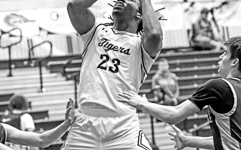 Emmanuel Harris battles Hallsville in the paint and scores for the Tigers.