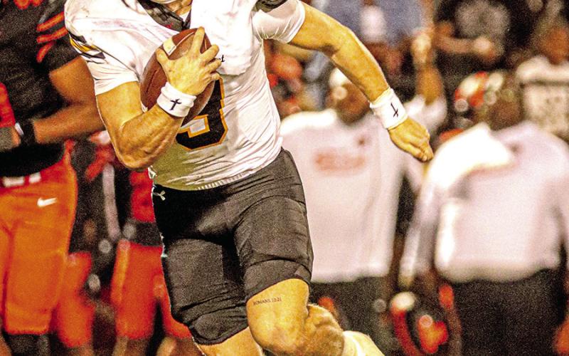 Mt. Pleasant Quarterback Carter Cook looks for an opening and picks up a first down against Texas High.(Cook-15/24 for 167 yards + 72 rushing yards-1 TD-1 INT)