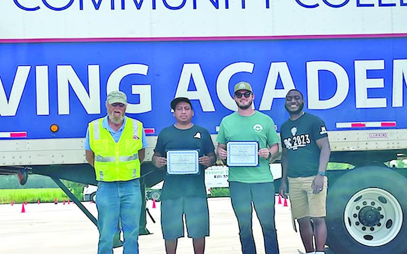 Pictured (from left): Bob Wentzell (instructor), graduates Jose Tierrablanca, Jonathon Cole and Jimmy Smith (director of continuing education and corporate training). COURTESY PHOTO